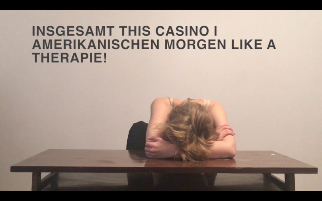 Text in background, Mara slumping on a table